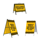 Drivers to Remain in Their Vehicles A-Frame Sign Stand is a durable steel black A-Frame sign stand with a double-sided sign message Drivers to Remain in vehicles until advised by staff with caution stripe border top and bottom on a yellow background.