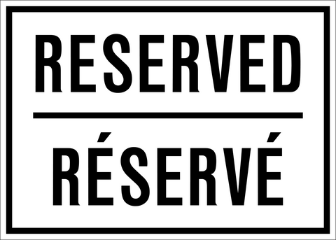 A black and white reserved parking sign with text in English and French.