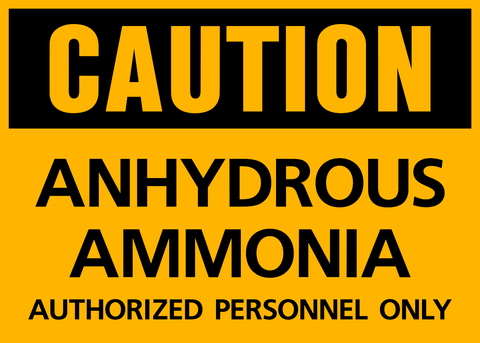 This black and yellow sign says CAUTION at the top. The remaining text says ANHYDROUS AMMONIA AUTHORIZED PERSONNEL ONLY.