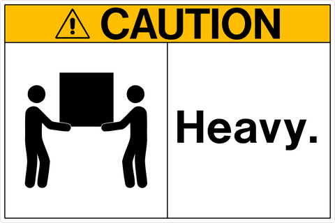 Sign with a yellow background and the words 'CAUTION - HEAVY.' above a pictogram of two people lifting a heavy object.