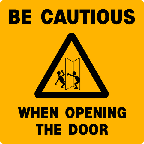 A yellow safety sign with a black triangle and a graphic of two silhouetted figures representing people opening a door. The text on the sign reads 'BE CAUTIOUS WHEN OPENING THE DOOR'.