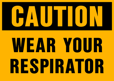 A yellow sign with black text saying 'CAUTION WEAR YOUR RESPIRATOR'.