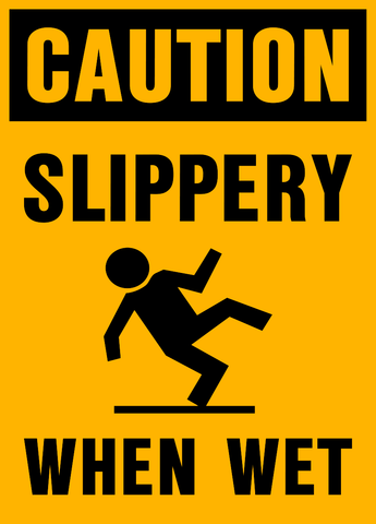 Yellow sign with black text and icon indicating 'CAUTION SLIPPERY WHEN WET'.