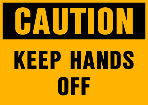 A yellow sign with black text saying 'CAUTION KEEP HANDS OFF'.