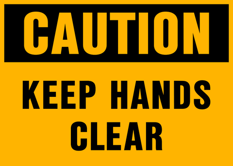 A yellow sign with black text saying 'CAUTION KEEP HANDS CLEAR'.