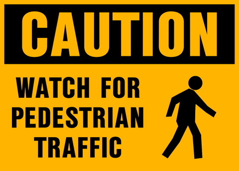 Caution sign with black text “Watch for Pedestrian Traffic” and walking person symbol on yellow background for safety visibility.