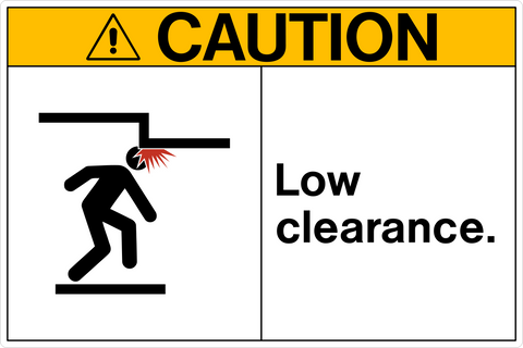 A safety sign with a yellow border and a black and white pictogram showing a person tripping over a low ceiling, along with the text 'CAUTION LOW CLEARANCE.'.