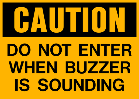 A bold yellow sign that says CAUTION DO NOT ENTER WHEN BUZZER IS SOUNDING