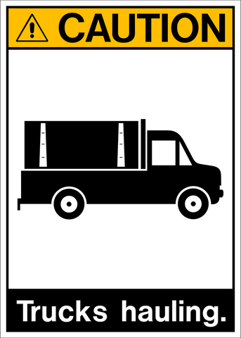 A white safety sign with a black pictogram of a truck and the text 'CAUTION: TRUCKS HAULING.' The sign has a yellow warning triangle at the top.