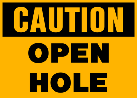 A black and yellow caution sign warning of an open hole.