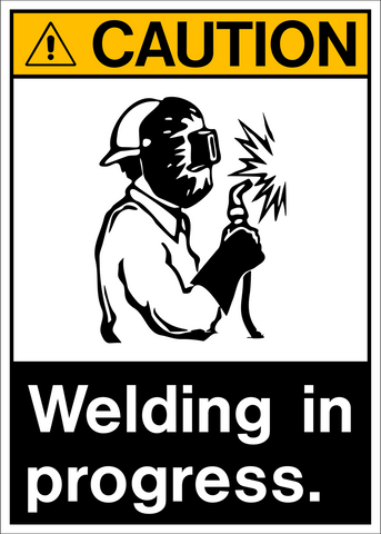A safety sign with a white and black background featuring a pictogram of a person welding and text that reads 'CAUTION WELDING IN PROGRESS.'.