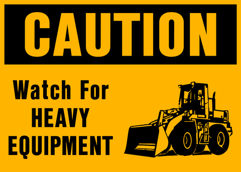 A yellow safety sign with the words 'CAUTION WATCH FOR HEAVY EQUIPMENT' and an illustration of a construction vehicle.