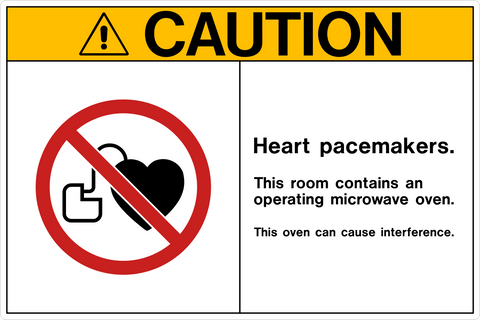 Caution sign showing a heart pacemaker symbol crossed out, warning that the room contains an operating microwave oven that can cause interference. Black and yellow safety design.
