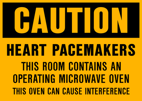 Caution sign with message “Heart Pacemakers – This room contains an operating microwave oven. This oven can cause interference.” Black text on yellow background for safety awareness.