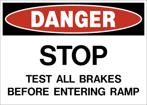 A rectangular safety sign with a white background and red and black text that reads 'DANGER STOP TEST ALL BRAKES BEFORE ENTERING RAMP'.