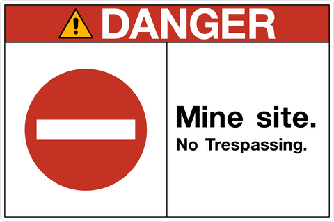 A rectangular sign with a white background and red border, featuring the text 'DANGER MINE SITE. NO TRESPASSING.