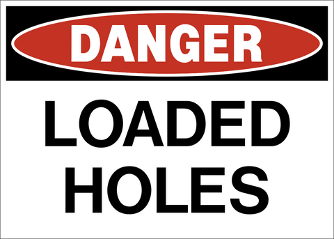 Loaded Holes Danger Sign warning workers that loaded blast holes are present in the area.