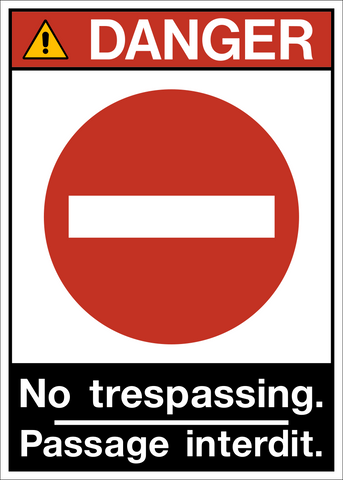 A bilingual 'DANGER NO TRESPASSING' sign with a red and white color scheme and a pictogram of a padlock.