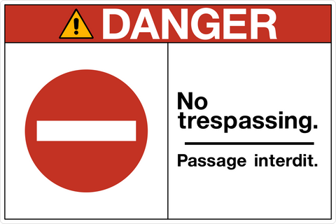 OSHA bilingual No Trespassing Danger Sign with no entry symbol and bilingual warning text.