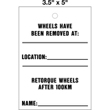 Wheel Retorque 100 KM Lock Out Tag is a single-sided safety tag with a white background and black text that reads 'WHEELS HAVE BEEN REMOVED RETORQUE WHEELS AFTER 100KM' with a space for location and name.