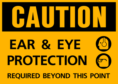 Yellow sign with black text and pictograms indicating 'CAUTION EAR & EYE PROTECTION REQUIRED BEYOND THIS POINT' along with symbols depicting ear and eye protection devices.