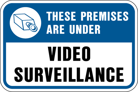 A blue and white sign with black text and an icon indicating 'These Premises are Under Video Surveillance' along with an image of a camera.