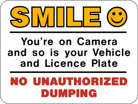 This rectangle sign says Smile you're on camera and so is your Vehicle and Licence Plate. No Unauthorized Dumping.